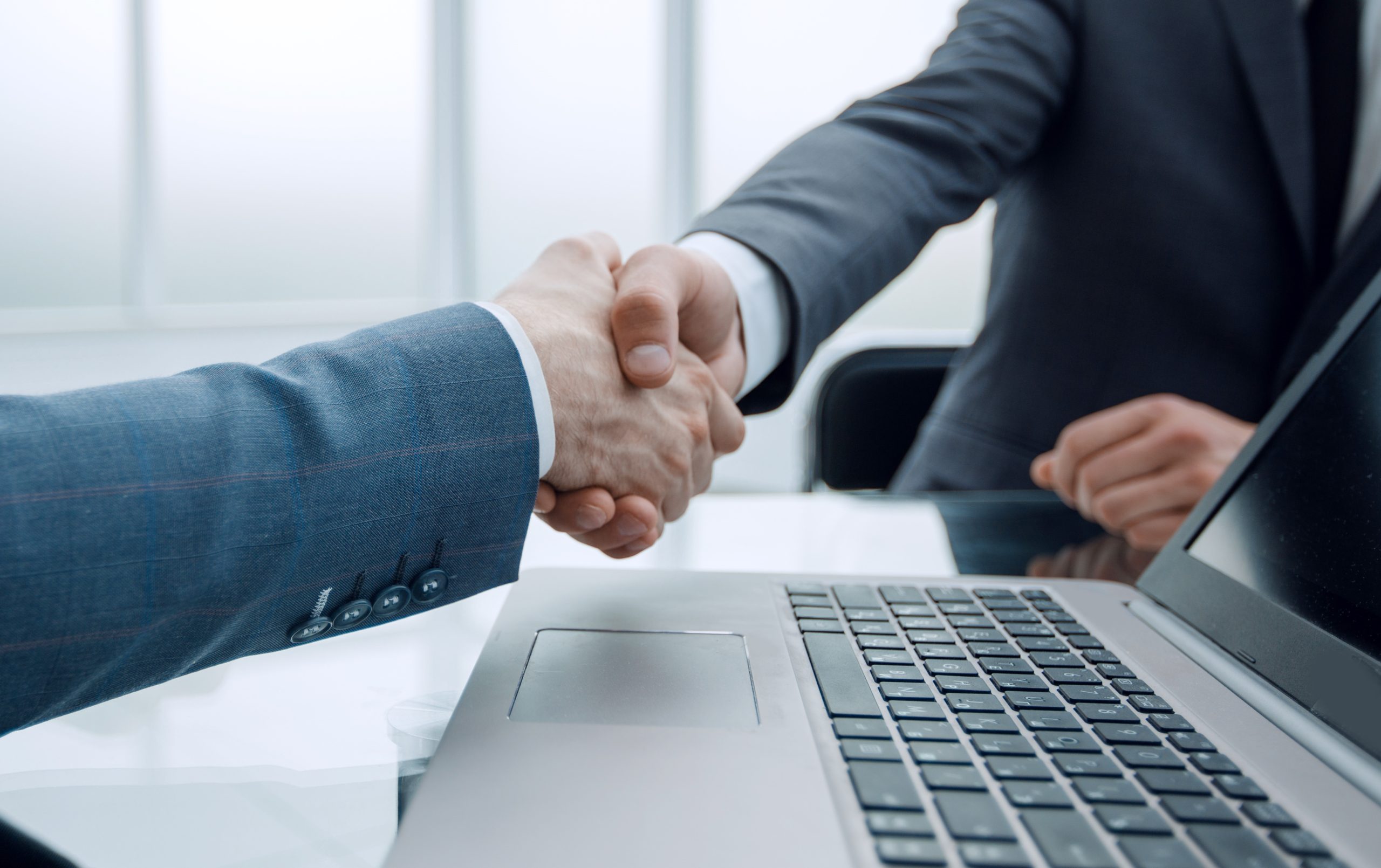 close up.business people shaking hands with each other, sitting